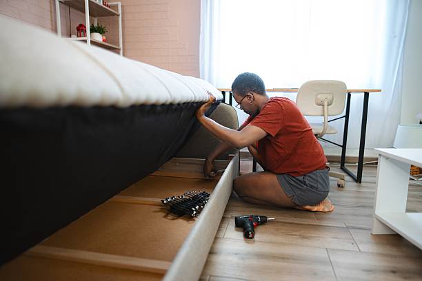 istock Woman assembling furniture in bedroom using a screwdriver 2228982031