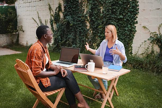 istock Two Businesswomen Working on Laptops in a Garden 2228982199