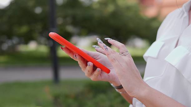 istock Group of Business Professionals Collaborating on Digital Devices Outdoors During Summer 2228982634