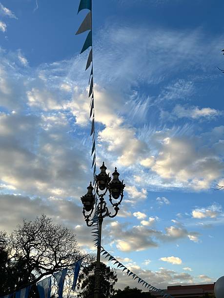 Antique lanterns, pennants, and cloudy sky in a park in Buenos Aires