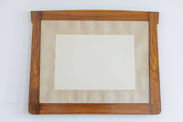 istock Framed blank antique picture frame with canvas resting on a wall 2228987159