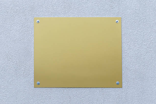 istock Blank golden sign mounted on a neutral wall 2228987197