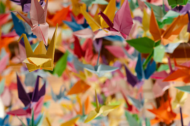 istock Colorful origami cranes hanging on with strings. 2228988204
