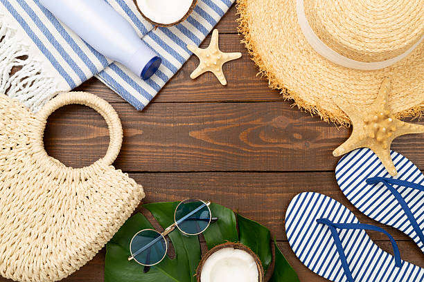 istock Blue beach accessories on wooden background, top view. Copy space for text 2228988527