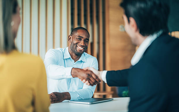 istock Meeting success. Business partners shaking hands 2228992345