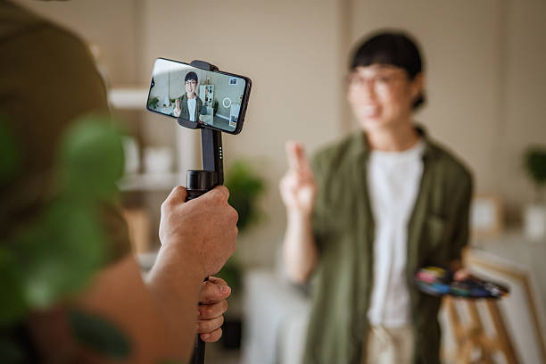 istock Man recording a painter creating online content with a gimbals 2228993013