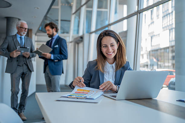 istock Businesswoman analyzing charts and working on laptop in modern office 2228993618