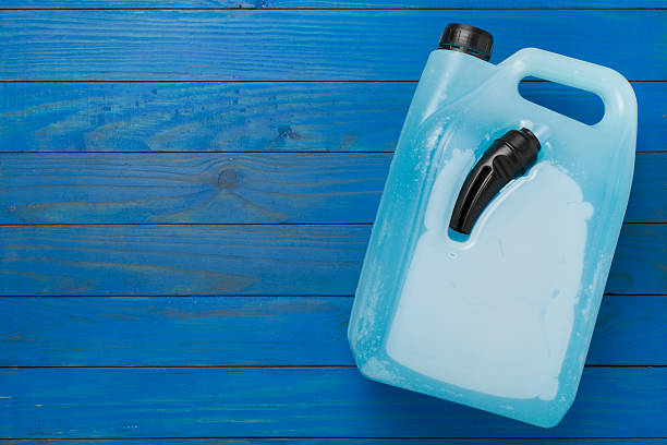 Can with antifreeze on concrete background, top view