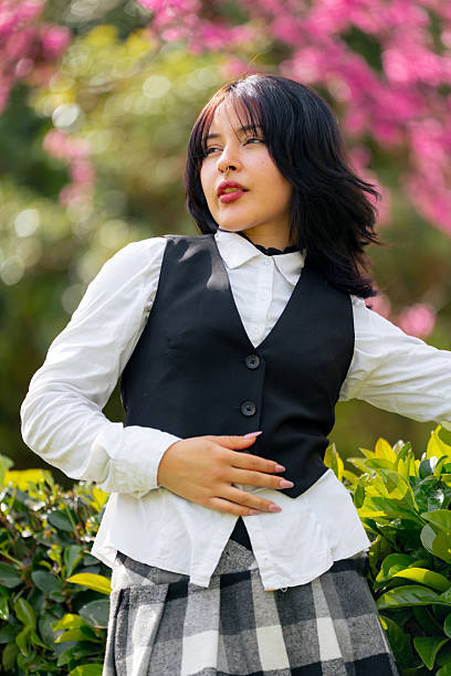 Studio shot  of a young hispanic woman, dressed as bsinessman