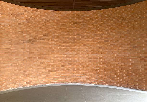 istock Curve orange brick wall and gray floor background. 2229000369