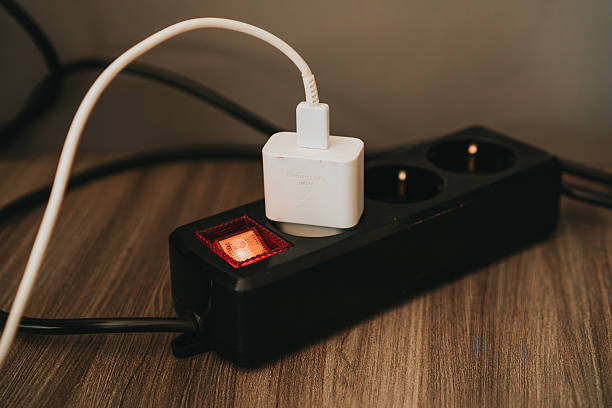 istock White Charger Plugged Into Black Power 2229001727