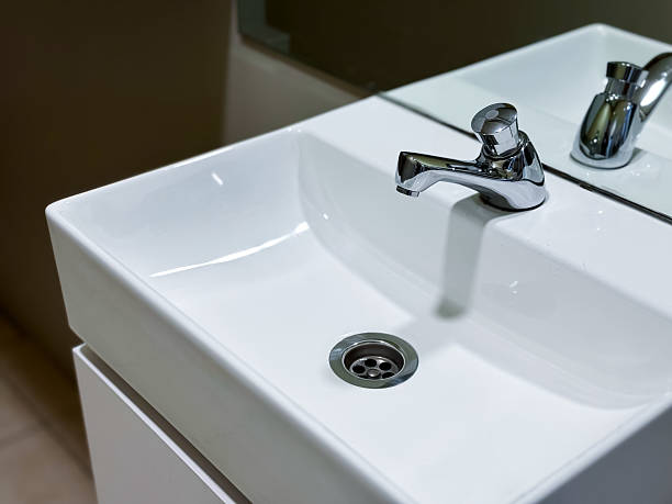 istock Modern white ceramic sink with chrome faucet in minimalist bathroom setting 2229004909