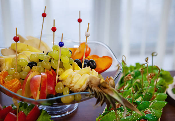 A colorful assortment of fresh fruits displayed in a clear bowl, enhancing the gathering atmosphere with visual appeal and flavor.