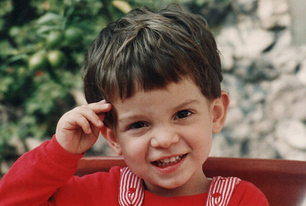 photo taken in 1980s: Smiling little boy looking at the camera