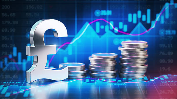 istock Metallic Pound Symbol and Coins Over Financial Chart Background 2229006205