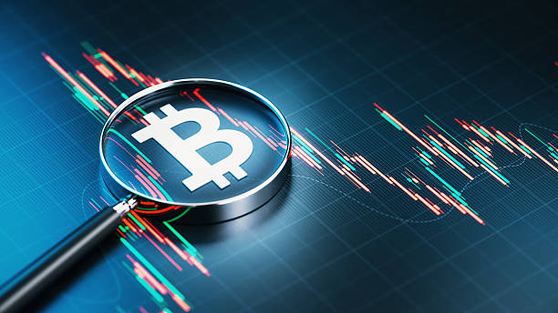 istock White Bitcoin Sign and Magnifying Glass Over Financial Bar Graph Background 2229006265