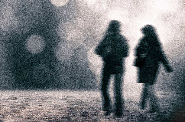 Two blurry women walking on street