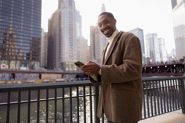 istock Young businessman using smartphone in chicago riverwalk 2229010524