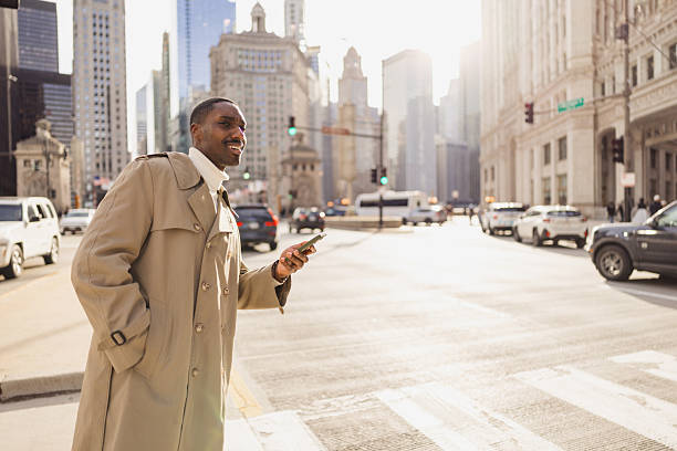 istock Businessman using smartphone while crossing street in chicago 2229010562