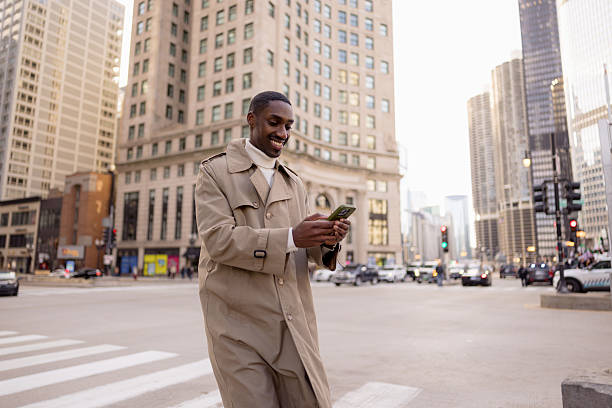 istock Smiling businessman using smartphone in city center 2229010565