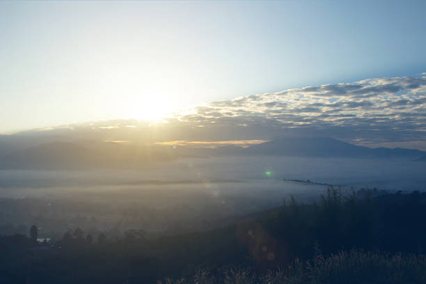 Natural background blurring warm colors and bright sun light. Sky sunny color orange light patterns plain abstract flare evening clouds blur.