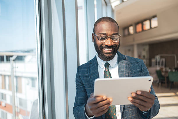 istock Smiling professional in a bright office holding a tablet 2229013726