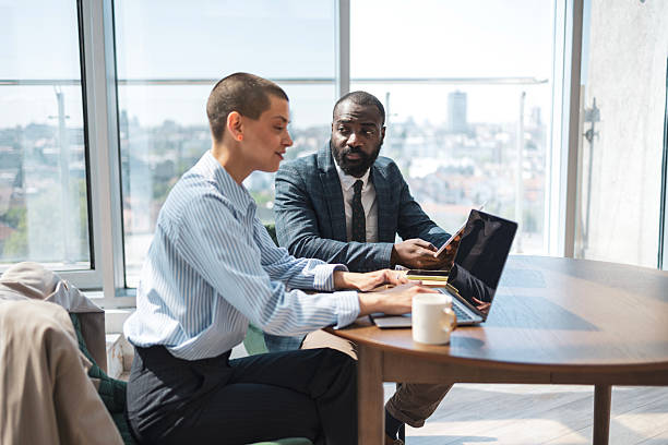 istock Business professionals collaborating in a modern, sunlit office environment. 2229013781