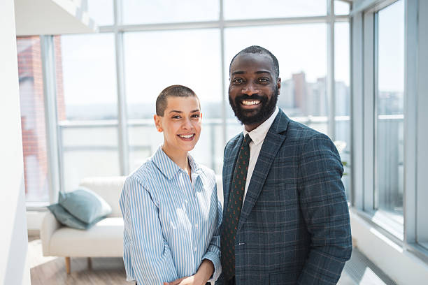 istock Confident business professionals in a modern, brightly lit office setting 2229013797