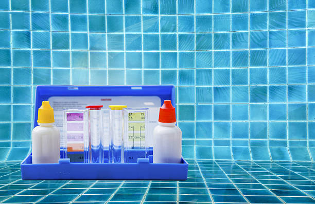 istock Water tester test kit on wooden table over clear water background 2229014355