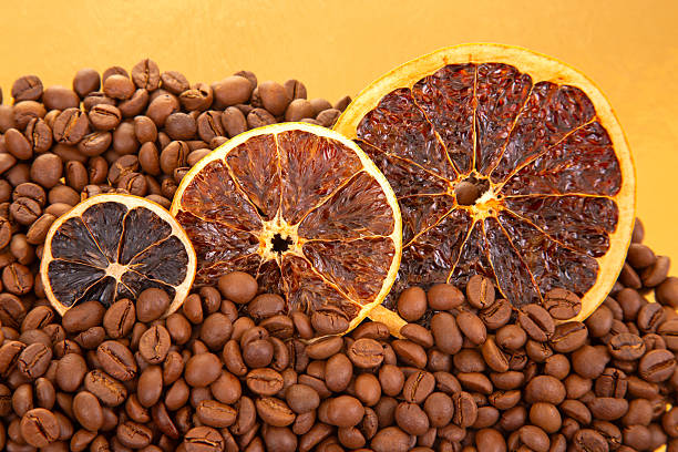 istock Roasted coffee beans surround dried orange slices on a golden reflective surface, evoking a warm, aromatic vibe for gourmet food photography. coffee aroma and taste citrus descriptors 2229020671