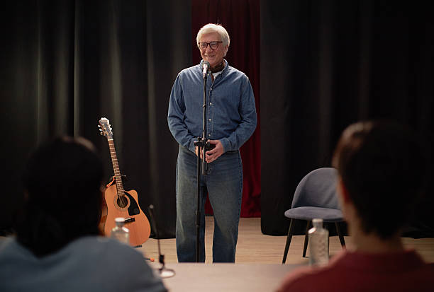 istock Senior Caucasian Man Performing Stand up Comedy during Talent Competition 2229020961