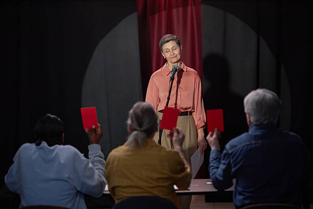 Caucasian Woman Performing on Stage Facing Judges during Talent Competition