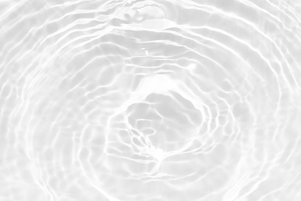 istock White water with ripples on the surface. Defocus blurred transparent white colored clear calm water surface texture with splashes and bubbles. Water waves with shining pattern texture background. 2229023366