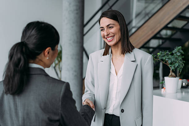 istock Business persons shaking hands in office. 2229024411