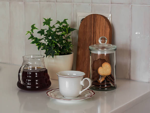 istock Coffee break - coffee pot, cookie jar, cup of coffee on the kitchen table 2229025421