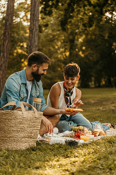 istock Couple enjoying romantic picnic in a park 2229032141