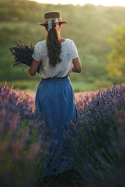 istock Woman Walking Through Lavender Field at Sunset 2229033189