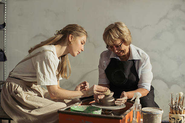 istock Senior woman learning pottery making with teacher 2229033939