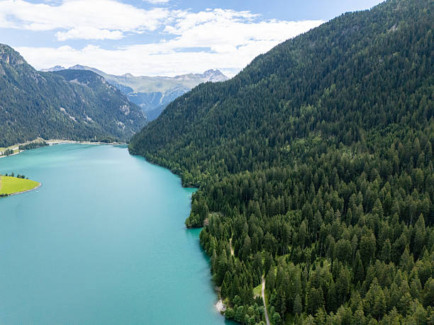 istock Mountain Lake Surrounded by Dense Green Forest 2229036970