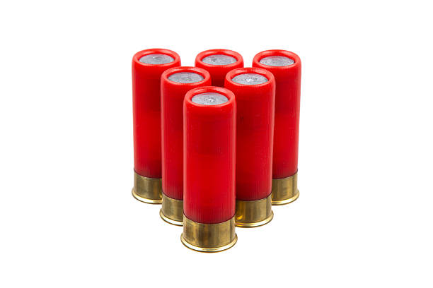 istock Six red shotgun shells with brass bases stand upright in a group. 2229037698