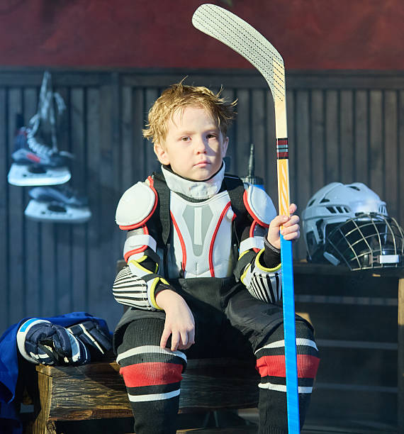 istock Tired little boy hockey player resting after match 2229042564