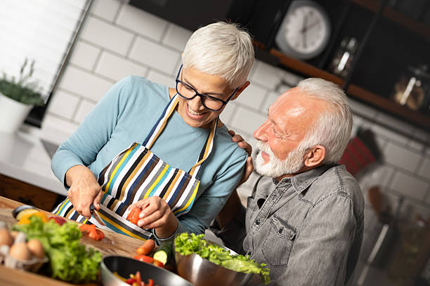 istock Senior couple cooking together at home 2229043932