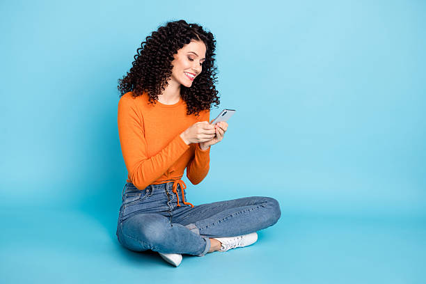 istock Portrait of attractive focused cheerful girl sitting using device browsing comment feedback media isolated over bright blue color background 2229044757