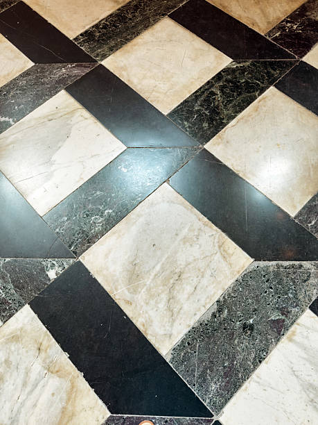 istock Worn geometric marble floor pattern with black and beige tiles in historical building interior, ancient architecture texture detail 2229046047