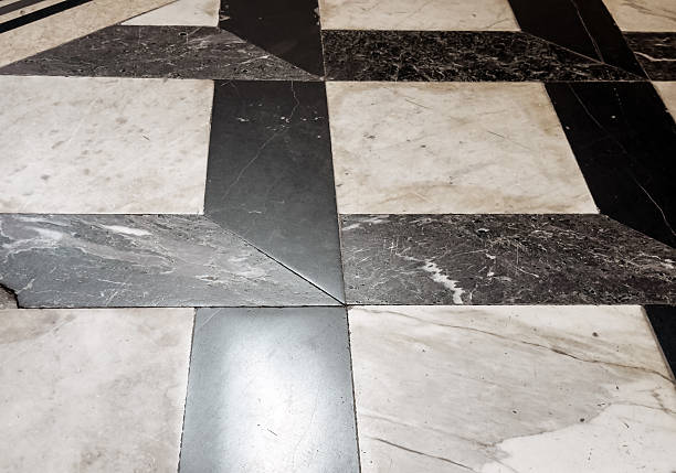 istock Worn geometric marble floor pattern with black and beige tiles in historical building interior, ancient architecture texture detail 2229046070