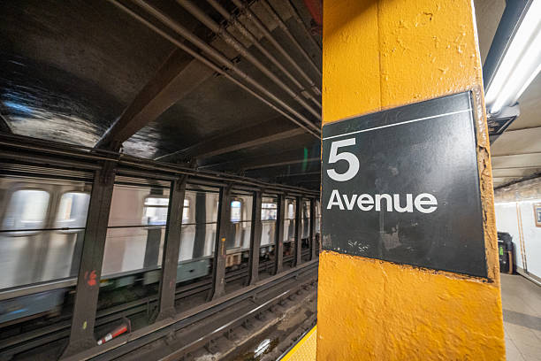 Modern design and busy crowd inside New York’s Fifth Avenue subway station platform