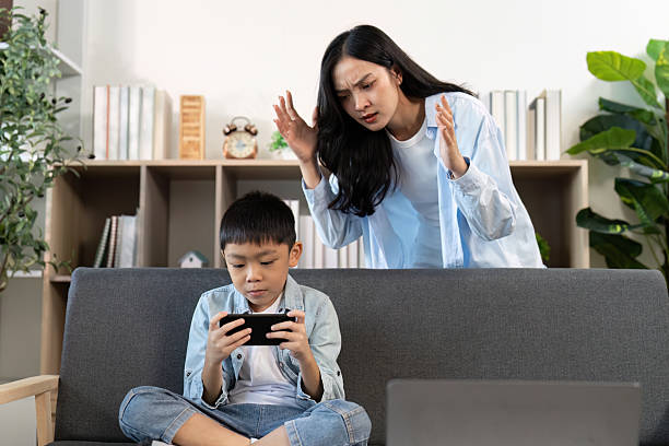 Mother scolding son for excessive gaming at home