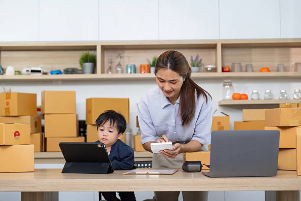 istock Mother Assisting Child with Tablet in Home Office 2229048245