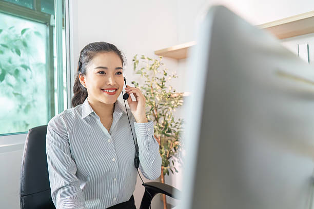 istock Remote Work. Cheerful woman on headset engaged in virtual meeting at home office. 2229049731