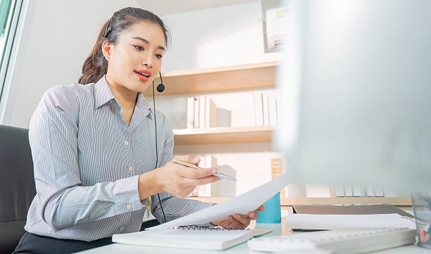 istock Remote Work. Professional woman reviewing documents during virtual meeting. 2229050162